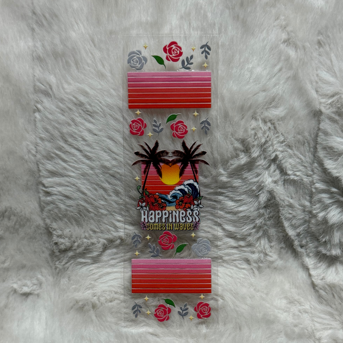 A rectangular UV DTF pen wrap featuring a sunset, palm trees, and the text Happiness Comes in Waves.