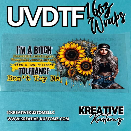 A UV DTF cup wrap featuring sunflowers, a tattooed woman, and bold text on a clear backing.